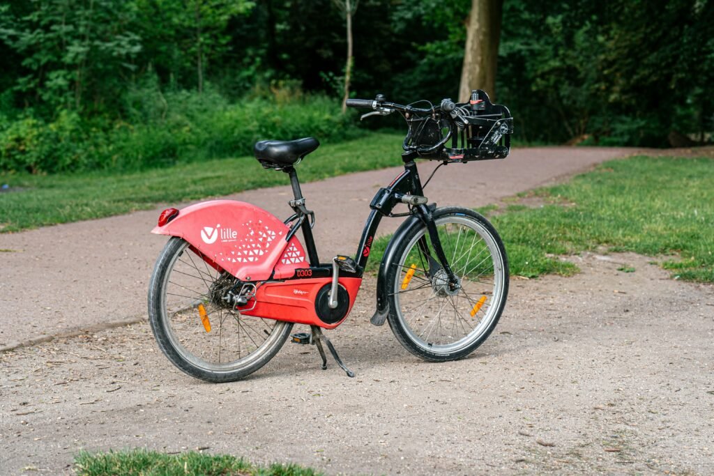 a red bicycle is parked on the side of the road